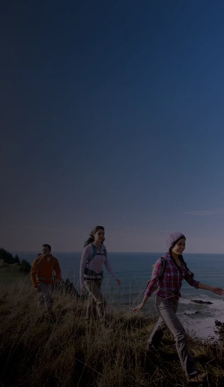 A group of people hiking near the ocean