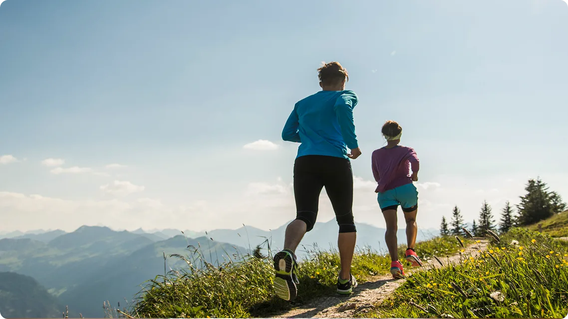 A young couple jogging in mountains